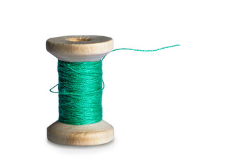 Green sewing thread on an old bobbin