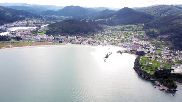 Aerial perspective of beautiful landscaped of Galicia. View of Covas city, at left is Viveiro city. Villages at the base of the mountain. Typically Galician landscape. Camera track right