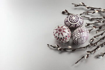Easter eggs on a silver background with willow twigs