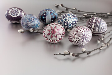 Easter eggs on a silver background with willow twigs