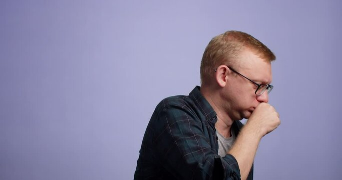 Portrait caucasian man in eyewear with expressions on face vomit disgusting smell, on blue background