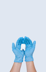 Doctor hands holding big tooth on blue background. Healthy care teeth concept. Top view, flat lay. Copy space for your text.