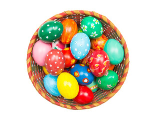 Easter basket with handmade colored eggs on nest. Top view. Isolated by background