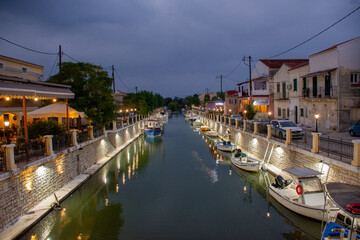 Fototapeta na wymiar Bridge over water canal in Lefkimmi, small town on Corfu - Kerkyra Island
