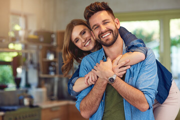 Nothing says home like unconditional love. Portrait of a happy young couple embracing at home.