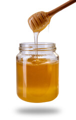 Honey dripping from wooden honey dipper in glass jar, acacia honey