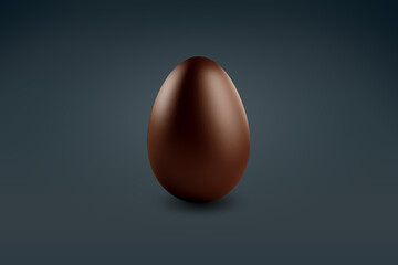 milk chocolate Easter egg on a dark floor