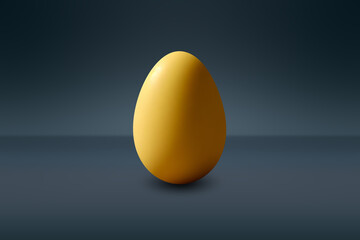 yellow Egg in front of a dark wall and on a dark floor