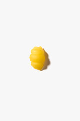 One piece of pasta gnoccetti on the white background.