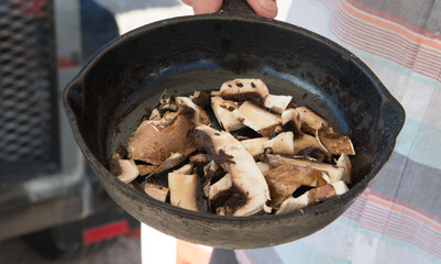 preparing mushrooms in a cast iron pan