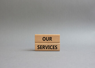 Our services symbol. Concept words Our services on wooden blocks. Beautiful grey background. Business and Our services concept. Copy space.