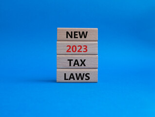 New 2023 Tax Law symbol. Wooden blocks with words New 2023 Tax Law. Beautiful blue background. Business and New 2023 Tax Law concept. Copy space.