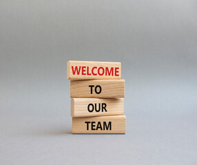 Welcome to our team symbol. Concept words Welcome to our team on wooden blocks. Beautiful grey background. Business and Welcome to our team concept. Copy space.