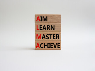 Aim Learn Master Achieve symbol. Concept word Aim Learn Master Achieve on wooden blocks. Beautiful white background. Business and Aim Learn Master Achieve concept. Copy space