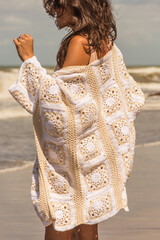 woman on the beach in crochet cardigan, granny squares, spring summer outfit