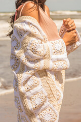 woman on the beach in crochet cardigan, granny squares, spring summer outfit
