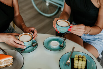 woman details hands drinking coffee eating cakes and macaroons popsi nails inspo aesthetic
