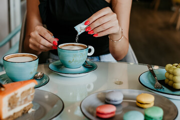 woman details hands drinking coffee eating cakes and macaroons popsi nails inspo aesthetic