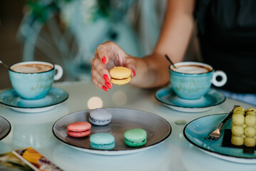 woman details hands drinking coffee eating cakes and macaroons popsi nails inspo aesthetic