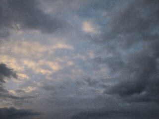 Obraz premium Dark clouds try to dominate the sky, sunset with colored clouds reminiscent of gold