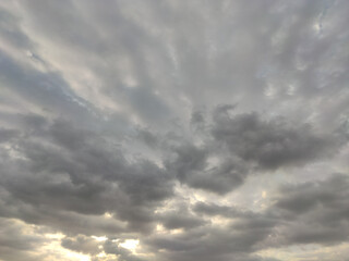 Obraz premium Oddly shaped clouds, cloud in the shape of arms. Sunset