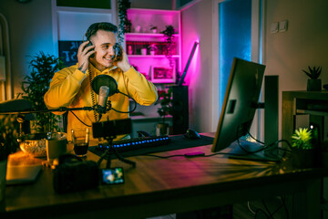 Young man male gamer playing computer game streaming video online