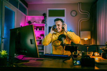 Young man male gamer playing computer game streaming video online