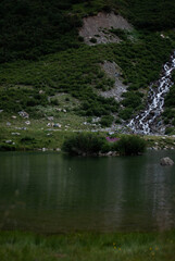 View on lake in green mountains in Alps