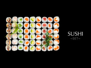 Variety of Japanese Maki sushi roll pieces isolated on black background. Large set with salmon, tuna, shrimp, avocado, cucumber with micro greens on top. Ready banner concept with text, copy space