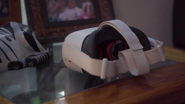 A Young Woman Grabs Her Vr Headset and Vr Controllers
