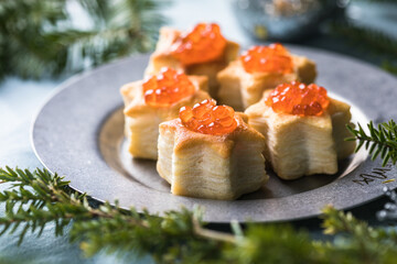 Christmas tree canape or sandwich with cucumber slice, salmon for festive x-mas snack. New year recipe