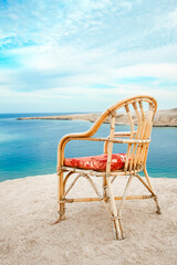 Fototapeta na wymiar Stylishly beautiful chair on the sea nature landscape background