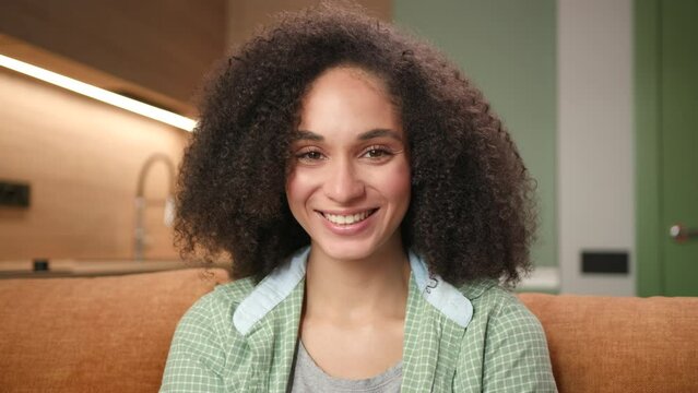 Smiling Mixed Race Woman Portrait. Confident 20s female laughing looking at camera. Joyful person at home.