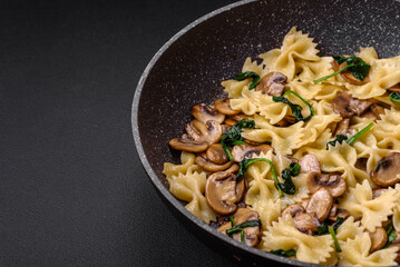 Delicious farfalle pasta with mushrooms, cheese and spinach with spices