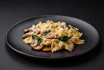 Delicious farfalle pasta with mushrooms, cheese and spinach with spices
