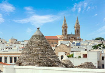Trulli houses in main touristic district of Alberobello beautiful old historic town, Apulia region,...