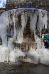 NEW YORK, NEW YORK – USA DECEMBER 25 2022: The Josephine Shaw Lowell Memorial Fountain is frozen in Bryant Park on Christmas Day due to the coldest cold wave for past 20 years at Midtown Manhattan.