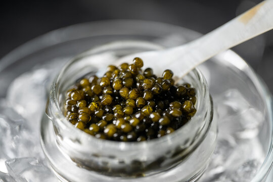 black caviar on ice with pearl spoon
