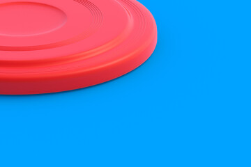 Frisbee disk on blue background. Summertime vacation. Toy for game on beach. Summer leisure. Copy space. 3d render