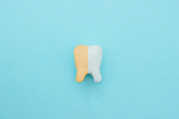 Unhealthy tooth white molar model with Clean and dirty tooth before and after whitening on pastel...