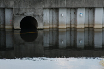 Culvert Opening in Pond Daylight Water Reflection