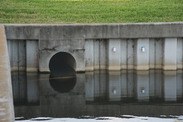 Culvert Opening in Pond Daylight Water Reflection