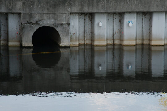 Culvert Opening in Pond Daylight Water Reflection