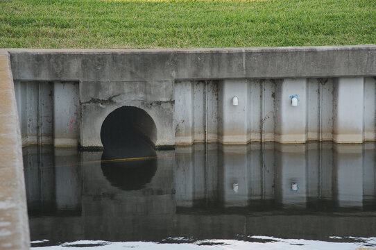 Culvert Opening in Pond Daylight Water Reflection