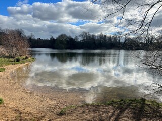 Landscape of Norfolk Broad with sandy shore by large lake , the Spring blue sky with sun light...