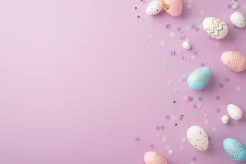 Keuken spatwand met foto Easter celebration concept. Top view photo of pink blue white easter eggs and confetti on isolated lilac background with copyspace © ActionGP