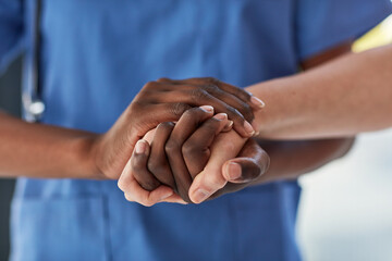 Never lose hope. Closeup shot of a medical practitioner holding a patients hand in comfort.