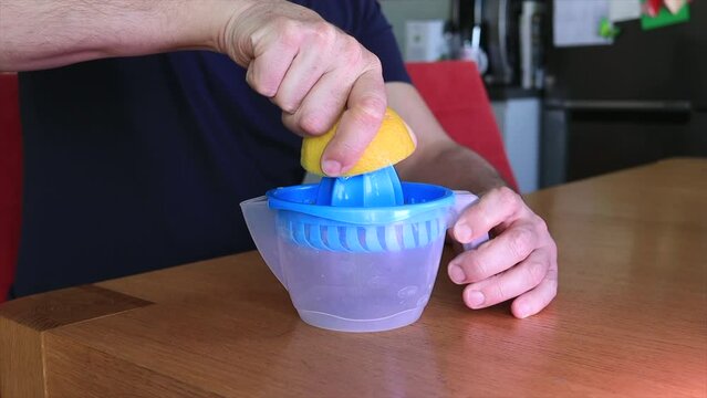 Squeezing lemon juice. Lemon fruit. A men preparing fresh lemon juice. 