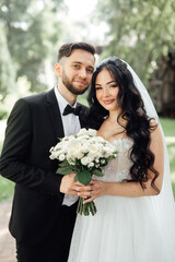 Amazing wedding couple. Beautiful bride and stylish groom.