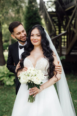 Amazing wedding couple. Beautiful bride and stylish groom.